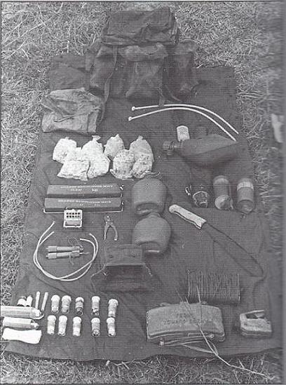 [SOG] <i>From book by MAJ John Plaster (Ret.) called SOG: A Photo History of the Secret Wars.</i>
A recon man's rucksack contained extra grenades, more canteens, a claymore mine, a medical kit, explosives, a banana knife, handcuffs, and rations (shown here on a lightweight sleeping bag).